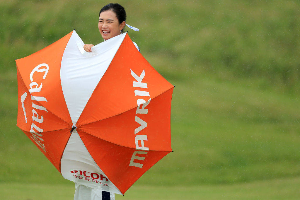 Yui Kawamoto shields herself from strong winds on day one of the 2020 AIG Women's Open